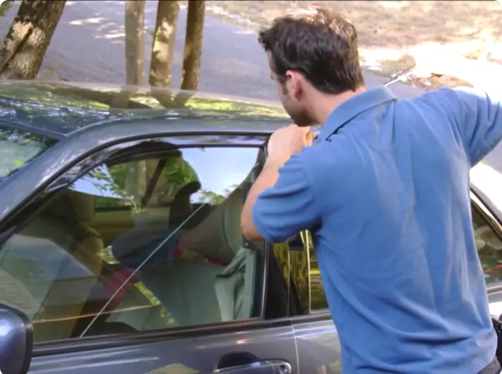 Automotive locksmith cutting and programming a car key in Waco, TX