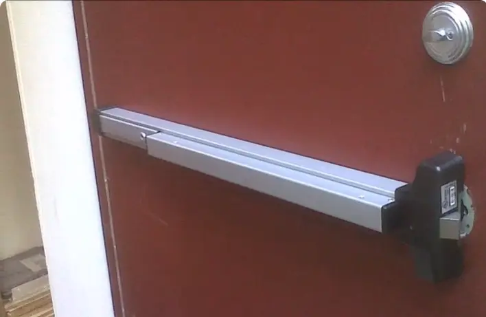 Commercial locksmith servicing a business door lock in Waco, TX