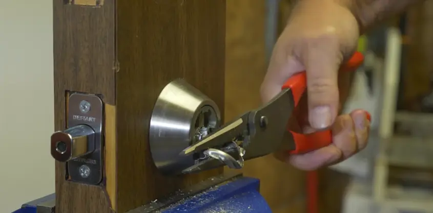 Technician rekeying a residential door lock